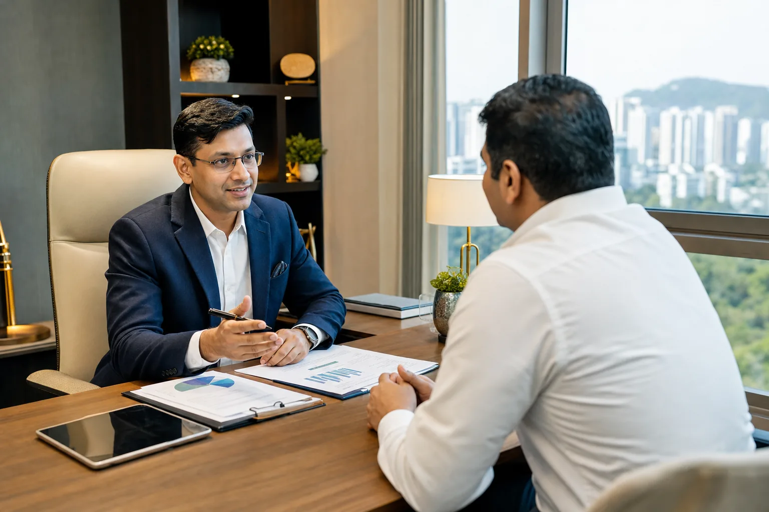 Professional Indian financial advisor consulting with an individual client in a sophisticated modern office